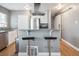 Open kitchen with breakfast bar, stainless steel appliances, granite countertops and modern fixtures at 20 S Harrison St, Denver, CO 80209