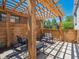 Cozy backyard patio with wooden pergola, outdoor furniture, and privacy fence at 20 S Harrison St, Denver, CO 80209