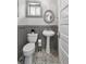 Stylish bathroom featuring patterned tile floors, a pedestal sink, and modern fixtures at 3316 N Columbine St, Denver, CO 80205