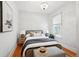 Charming bedroom with hardwood floors, patterned wallpaper, and a window offering natural light at 3316 N Columbine St, Denver, CO 80205