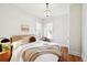 Well-lit bedroom featuring hardwood floors, comfortable bedding, and a decorative chandelier at 3316 N Columbine St, Denver, CO 80205