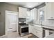 Updated kitchen with white cabinets, stainless steel appliances, farmhouse sink, and subway tile backsplash at 3316 N Columbine St, Denver, CO 80205