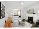 Bright and airy living room with white sofa, ottoman, fireplace and hardwood floors at 3316 N Columbine St, Denver, CO 80205