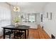 Open concept dining and living room with modern decor, dining table, sofa, fireplace, and hardwood floors at 3316 N Columbine St, Denver, CO 80205