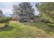 Spacious backyard featuring lush green lawn and mature landscaping; perfect for outdoor activities at 4114 S Niagara Way, Denver, CO 80237