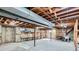 Unfinished basement with exposed ductwork, shelving, and concrete floor; ready for customization at 4114 S Niagara Way, Denver, CO 80237