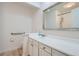 Bathroom with updated vanity, ample counter space, hand rails, and a shower reflected in the mirror at 4114 S Niagara Way, Denver, CO 80237