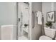 Walk in shower with glass door and toilet with towel rack above at 4114 S Niagara Way, Denver, CO 80237
