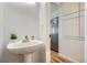 Bathroom sink and mirror next to stainless steel fridge at 4114 S Niagara Way, Denver, CO 80237