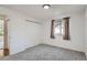 Carpeted bedroom with closet, window with curtains, and neutral walls for a serene space at 4114 S Niagara Way, Denver, CO 80237
