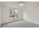 Inviting bedroom featuring neutral walls, large windows, and cozy carpet flooring at 4114 S Niagara Way, Denver, CO 80237