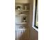 Detail of the built-in shelving next to a bright window at 4114 S Niagara Way, Denver, CO 80237