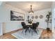 Dining room with modern chandelier and large abstract painting on wall, as well as dining table at 4114 S Niagara Way, Denver, CO 80237