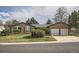 Lovely brick home with a two-car garage, lush green lawn, and mature trees at 4114 S Niagara Way, Denver, CO 80237