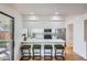 Bright kitchen features stainless steel appliances, a breakfast bar with seating, and sliding glass doors to the patio at 4114 S Niagara Way, Denver, CO 80237