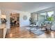 Bright living room with hardwood floors, large window, and stylish furnishings at 4114 S Niagara Way, Denver, CO 80237