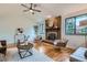Spacious living room featuring a brick fireplace and natural light from multiple windows at 4114 S Niagara Way, Denver, CO 80237