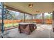 Shaded backyard patio featuring a covered dining area and view of the fenced yard and mature trees at 4114 S Niagara Way, Denver, CO 80237