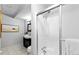 Bathroom with tiled floors, a single sink vanity, and a shower with a glass door at 16259 W 10Th Ave # I2, Golden, CO 80401