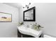 Bathroom featuring modern vanity, stylish mirror, and artwork, creating a serene and well-appointed space at 16259 W 10Th Ave # I2, Golden, CO 80401