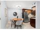 A dining area featuring modern chairs and a wooden table, complemented by a stainless steel refrigerator at 16259 W 10Th Ave # I2, Golden, CO 80401