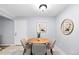 A dining area showcasing a round wooden table with modern chairs, with contemporary artwork enhancing the wall decor at 16259 W 10Th Ave # I2, Golden, CO 80401