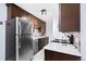 Modern kitchen featuring stainless steel appliances, dark wood cabinets, and mosaic backsplash, creating a sleek and functional space at 16259 W 10Th Ave # I2, Golden, CO 80401