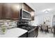 Bright kitchen with white countertops, stainless steel appliances, mosaic tile backsplash and adjacent dining area at 16259 W 10Th Ave # I2, Golden, CO 80401