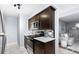 A stylish kitchen with stainless steel appliances, dark wood cabinetry, and an open view into the living area at 16259 W 10Th Ave # I2, Golden, CO 80401