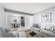 Open floor plan featuring a modern living area with stylish furniture and a view into the contemporary dining area at 16259 W 10Th Ave # I2, Golden, CO 80401