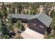 Beautiful aerial view of this home with attached three-car garage and mature trees at 8361 Piney Creek Rd, Parker, CO 80138