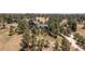 Stunning aerial view of a large estate surrounded by lush trees and open space at 8361 Piney Creek Rd, Parker, CO 80138