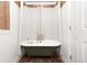 A luxurious bathroom features a classic clawfoot tub with elegant fixtures and a stylish shower curtain at 8361 Piney Creek Rd, Parker, CO 80138