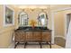 Bathroom featuring a double vanity with intricate design and decorative mirrors at 8361 Piney Creek Rd, Parker, CO 80138