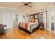 Bedroom features a modern bed frame, hardwood floors, and natural light from a window at 8361 Piney Creek Rd, Parker, CO 80138