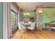 Dining room with a round table, cushioned chairs, and a window overlooking a lush, green landscape at 8361 Piney Creek Rd, Parker, CO 80138