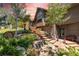 Stunning home exterior featuring stone accents, a wooden staircase, and lush landscaping under a vibrant sunset sky at 8361 Piney Creek Rd, Parker, CO 80138