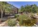 Beautiful landscaping, including a pond with a waterfall, surrounds this multi-story home at 8361 Piney Creek Rd, Parker, CO 80138