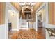 Inviting foyer with a decorative rug, staircase, and elegant furnishings, creating a warm and welcoming entrance at 8361 Piney Creek Rd, Parker, CO 80138