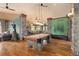 Spacious game room featuring a pool table, hardwood flooring, and stylish design elements at 8361 Piney Creek Rd, Parker, CO 80138