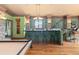 Inviting game room with a bar area, pool table, and hardwood floors, perfect for entertaining guests at 8361 Piney Creek Rd, Parker, CO 80138
