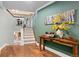 Inviting hallway with decorative table, artwork, and a view of the staircase leading to the upper level at 8361 Piney Creek Rd, Parker, CO 80138