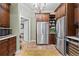 Spacious kitchen featuring stainless steel appliances, custom cabinetry, and tiled floor at 8361 Piney Creek Rd, Parker, CO 80138