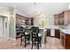 Inviting kitchen with breakfast bar, granite counters, dark cabinets, and modern stainless steel appliances at 8361 Piney Creek Rd, Parker, CO 80138