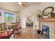 Bright living room with hardwood floors, fireplace, and an adjacent bedroom view with an ensuite bathroom at 8361 Piney Creek Rd, Parker, CO 80138