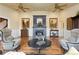 Cozy living room with a fireplace, hardwood floors, and elegant furnishings at 8361 Piney Creek Rd, Parker, CO 80138