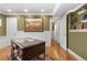 Spacious room with desk, a decorative painting, and an adjacent area with white doors and a staircase at 8361 Piney Creek Rd, Parker, CO 80138