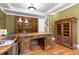 This office has an elegant wooden desk and cabinets, with rich wood flooring and large windows at 8361 Piney Creek Rd, Parker, CO 80138