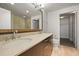 Bathroom featuring double sinks with updated fixtures and finishes, and a walk-in closet at 2001 Lincoln St # 2420, Denver, CO 80202