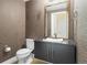 Powder room featuring geometric wallpaper, decorative mirror, and modern fixtures at 2001 Lincoln St # 2420, Denver, CO 80202